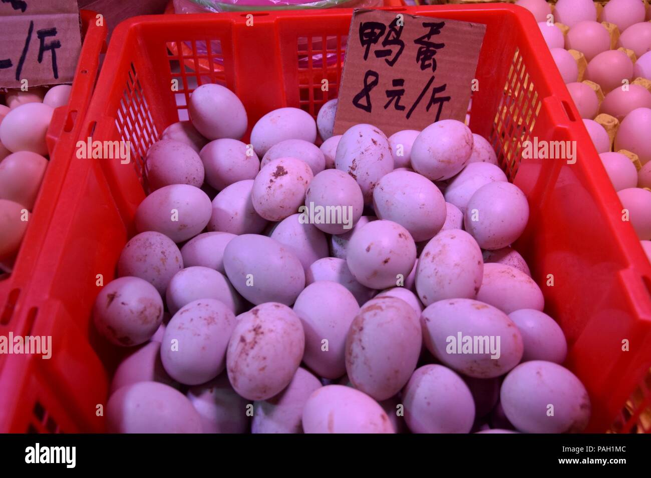 Fresh duck eggs heaped up inside the plastic basket. Translation "duck