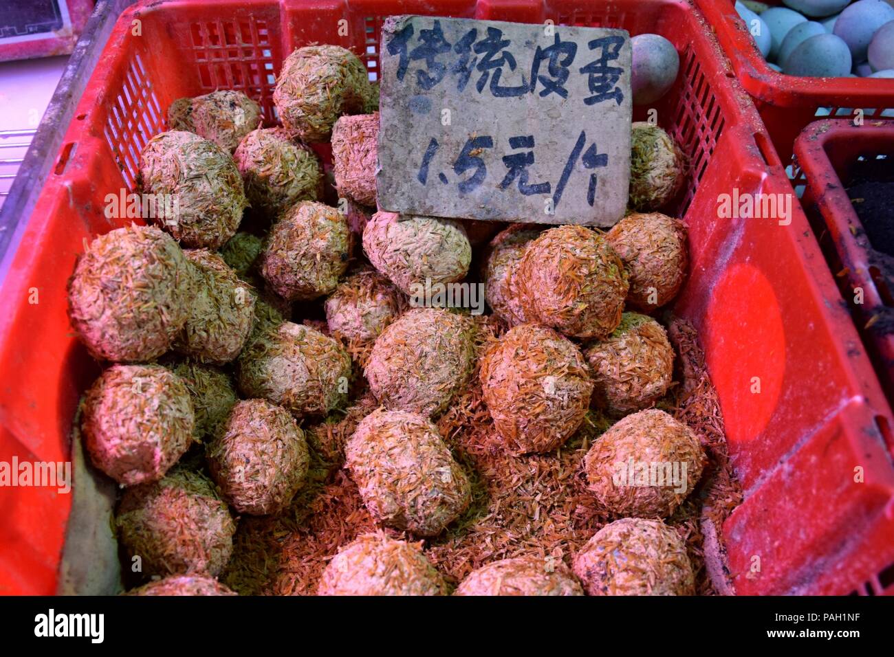 Preserved eggs heaped up inside the plastic basket. Translation
