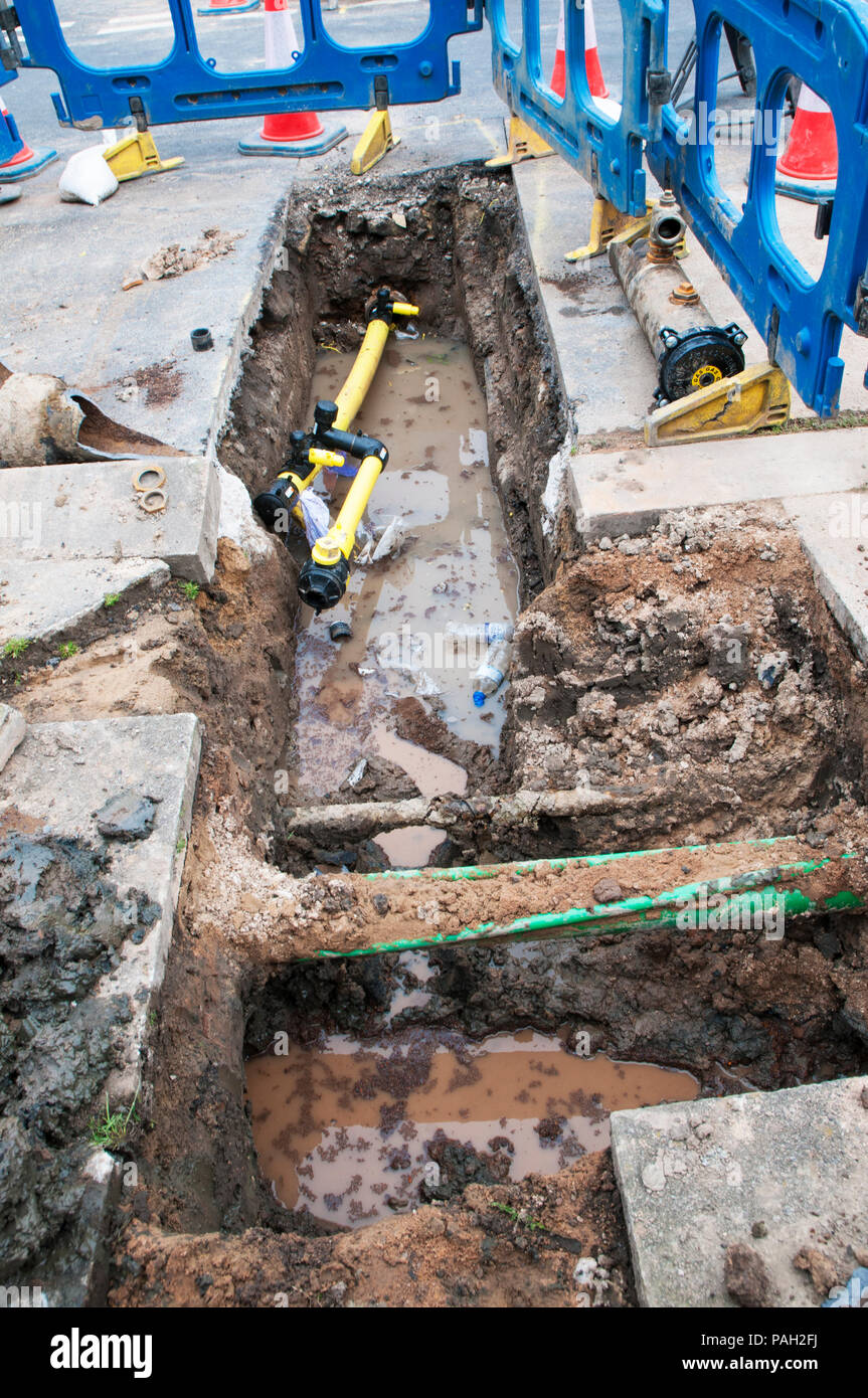 Roadway excavation to replace old cast iron gas main pipes.with plastic