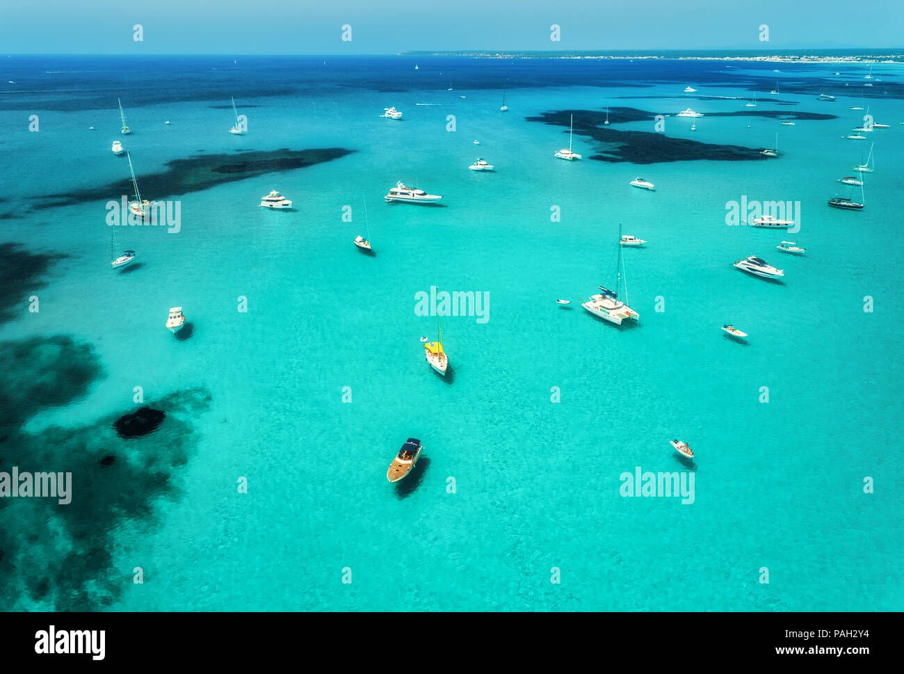 Aerial view of boats, luxury yachts and transparent sea at sunny day in Mallorca, Spain. Colorful summer landscape with marina bay, blue water, sandy  Stock Photo
