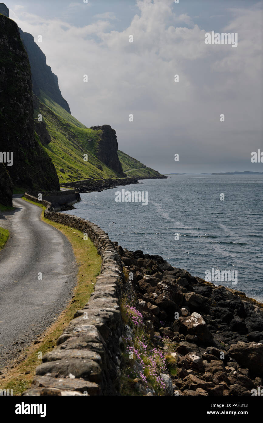 Steep cliffs and rock wall of Highway B8035 on the shore of Loch Na Keal on the Isle of Mull Scotland UK Stock Photo