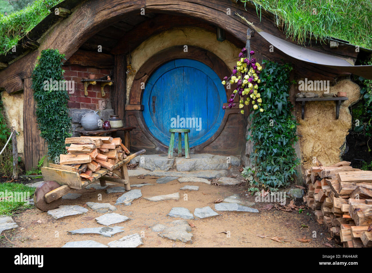 Hobbit Hole in the shire with firewood out the front Stock Photo