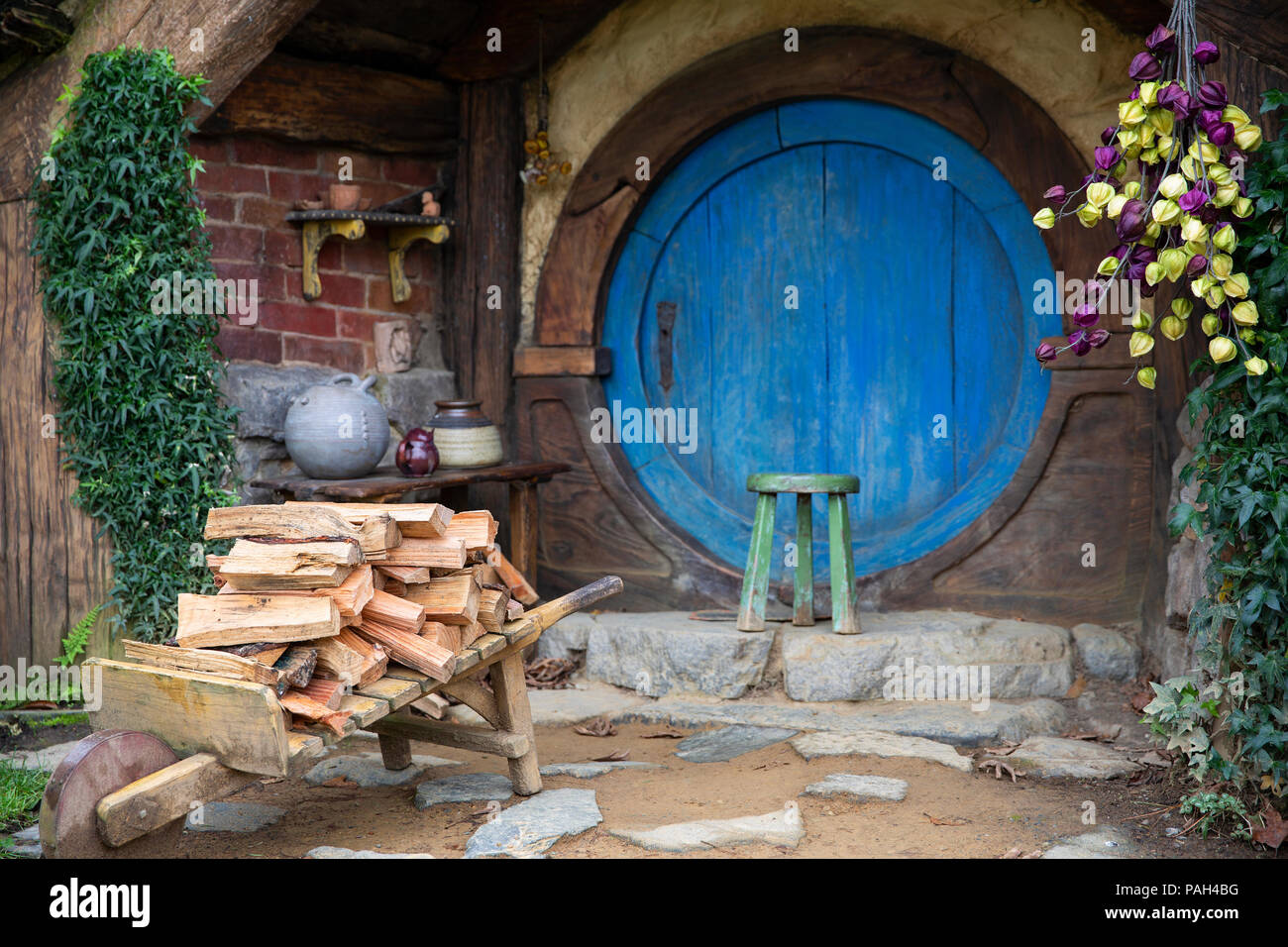Hobbit Hole in the shire with firewood out the front Stock Photo