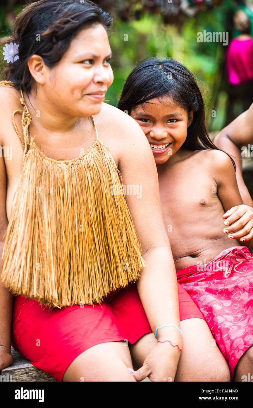 AMAZONIA, PERU - NOV 10, 2010: Unidentified Amazonian indigenous woman and her daughter. Indigenous people of Amazonia are protected by COICA (Coordin Stock Photo