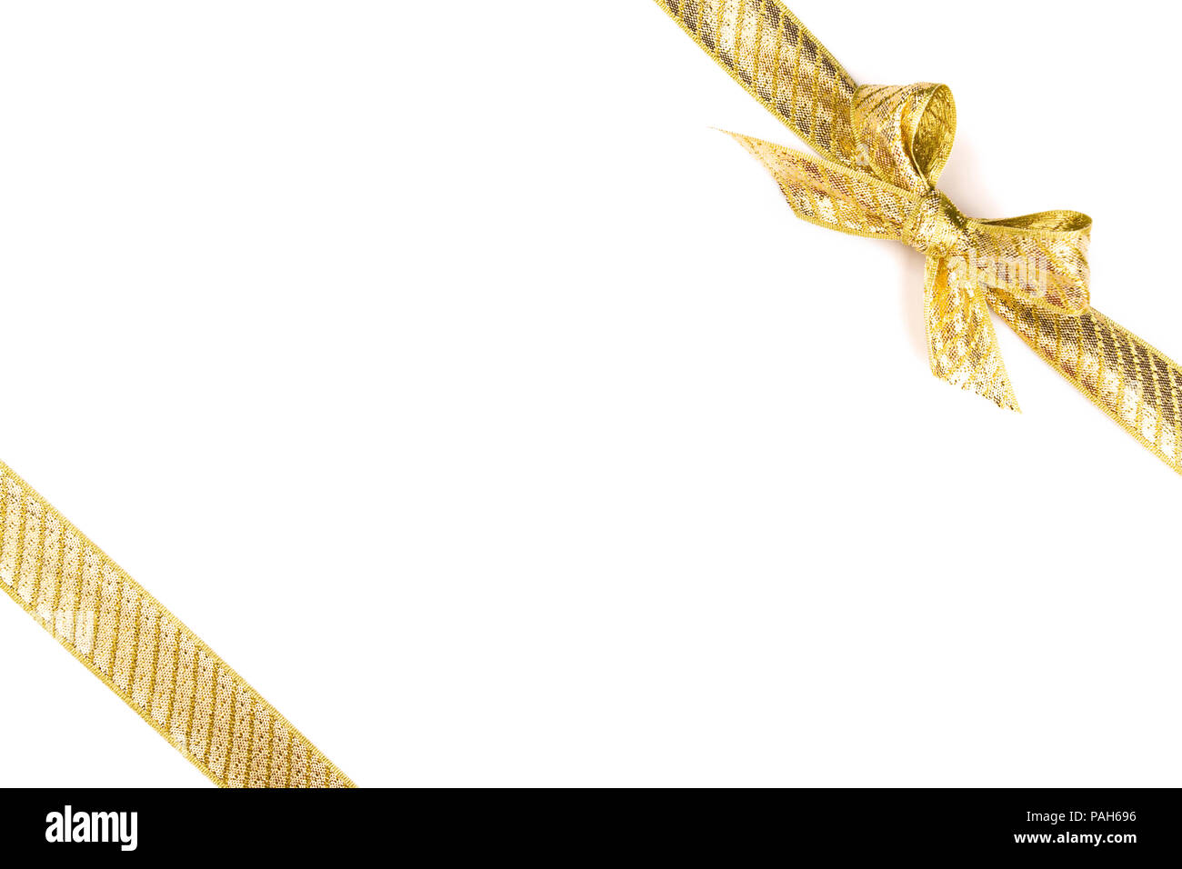 Gold bow tied using silk ribbon Stock Photo