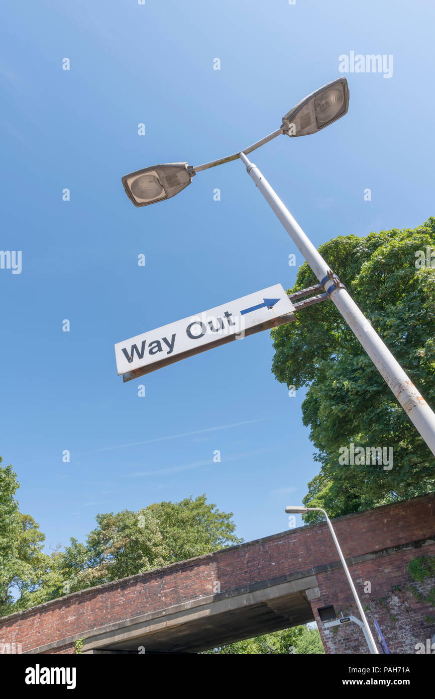 A Way Out sign attached to a lamppost at Lytham Railway Station, Lancashire, UK photographed against a blue sky Stock Photo