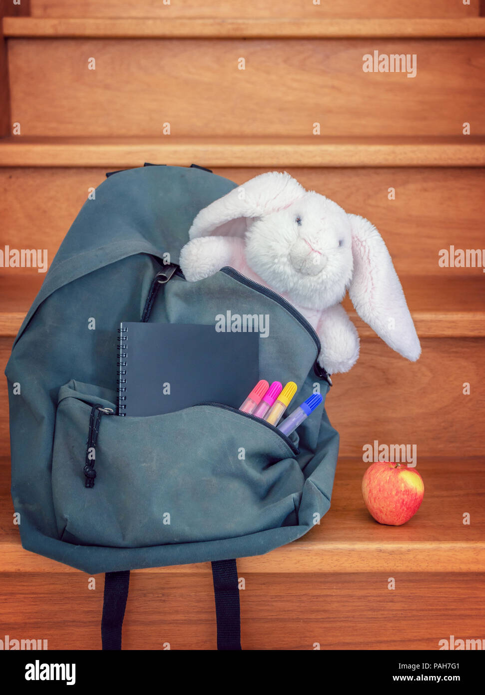 School bag with cuddly toy, supplies and lunch Stock Photo