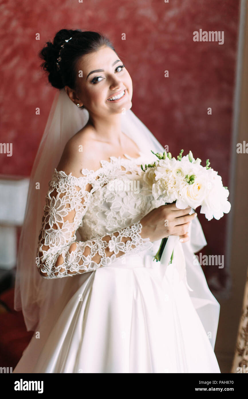 Half-length portrait of the happy bride with wedding bouquet of white ...