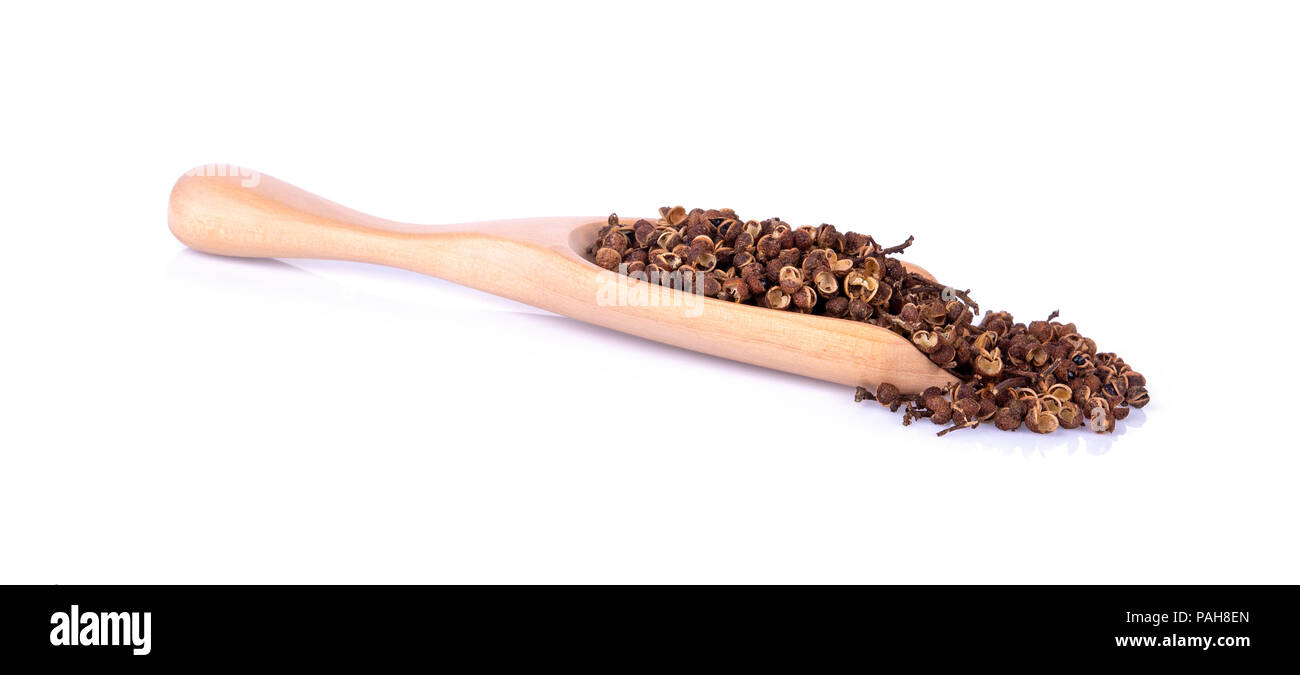 Dry Zanthozylum limonella Alston in wooden spoon on white background Stock Photo