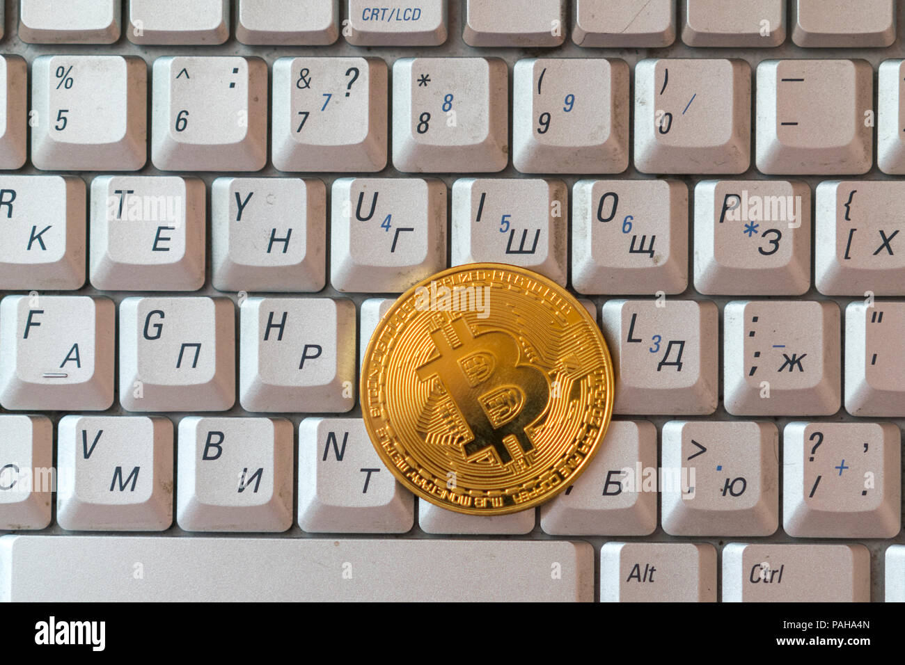 Coin crypto currency bitcoin lies on the keyboard background theme gold  exchange pyramid for money due to rise or fall exchange rate closeup Stock  Photo - Alamy