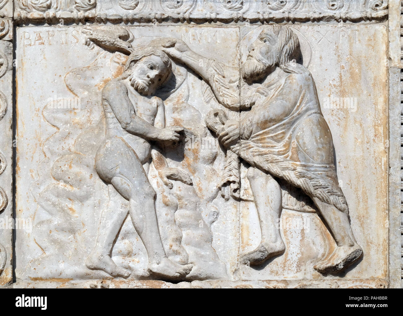 Baptism of the Christ, medieval relief on the facade of Basilica of San Zeno in Verona, Italy Stock Photo