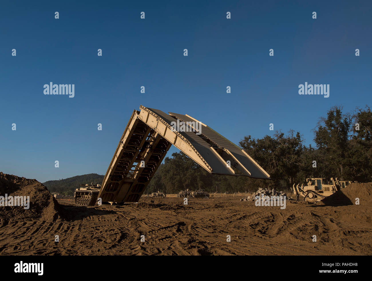 U.S. Army Reserve combat engineer Soldiers use an M60 Armored Vehicle-Launched Bridge to cross a gap on a combined arms breach during a Combat Support Training Exercise (CSTX) at Fort Hunter Liggett, California, July 22, 2018. This rotation of CSTX runs through the month of July, training thousands of U.S. Army Reserve Soldiers from a variety of functions to include military police, medical, chemical, logistics, transportation and more. (U.S. Army Reserve photo by Master Sgt. Michel Sauret) Stock Photo