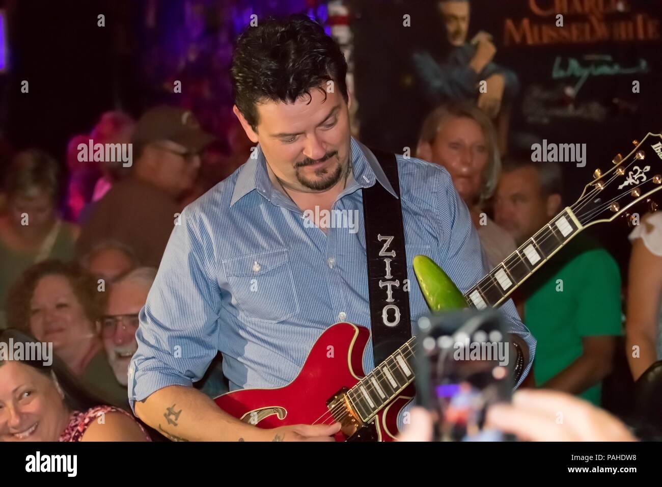 Mike Zito performs with a cucumber and his guitar at the legendary Zoo