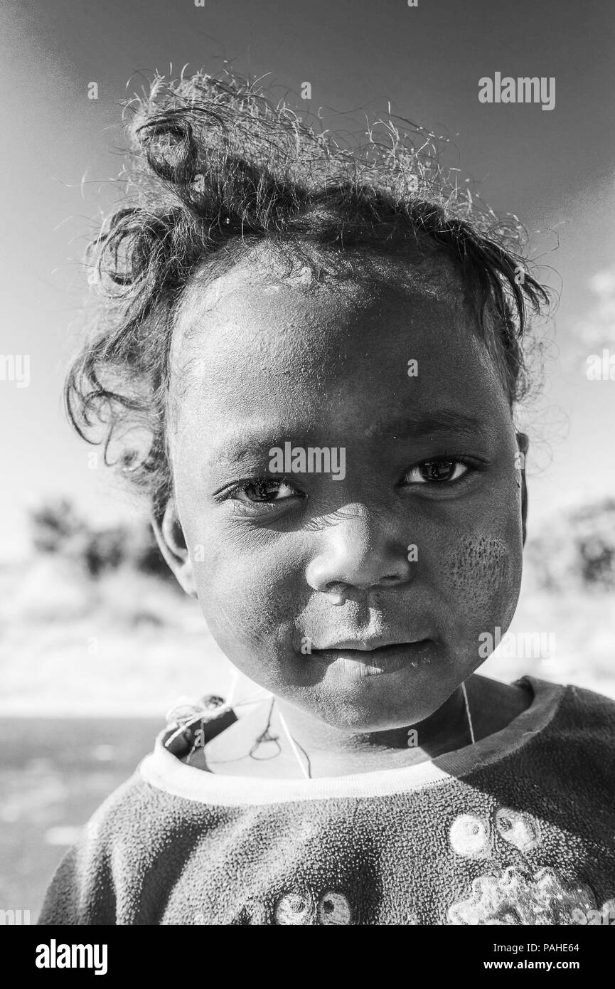 MADAGASCAR - JULY 3, 2011: Portrait of an unidentified girl with wierd hair cut in Madagascar, July 3, 2011. Children of Madagascar suffer of poverty  Stock Photo