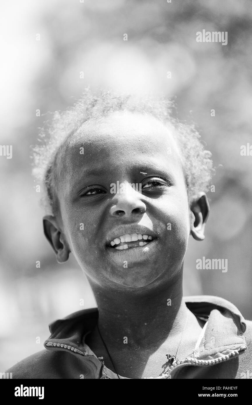 AKSUM, ETHIOPIA - SEP 24, 2011: Unidentified Ethiopian beautiful girl biting the fingers in Ethiopia, Sep.24, 2011. Children in Ethiopia suffer of pov Stock Photo