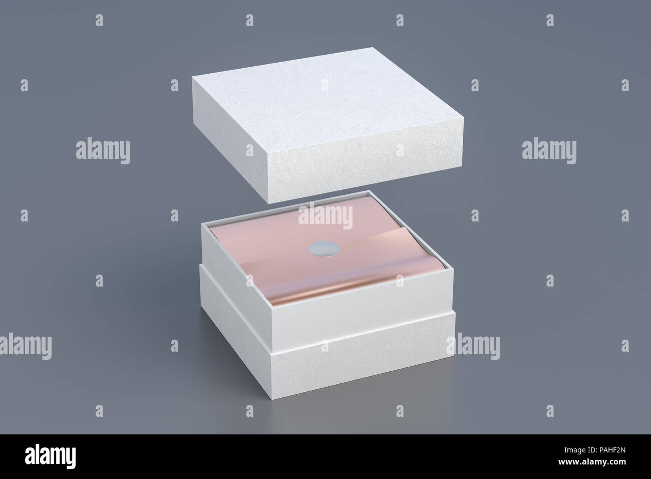 Opened white square box with copper wrapping paper inside box and cover