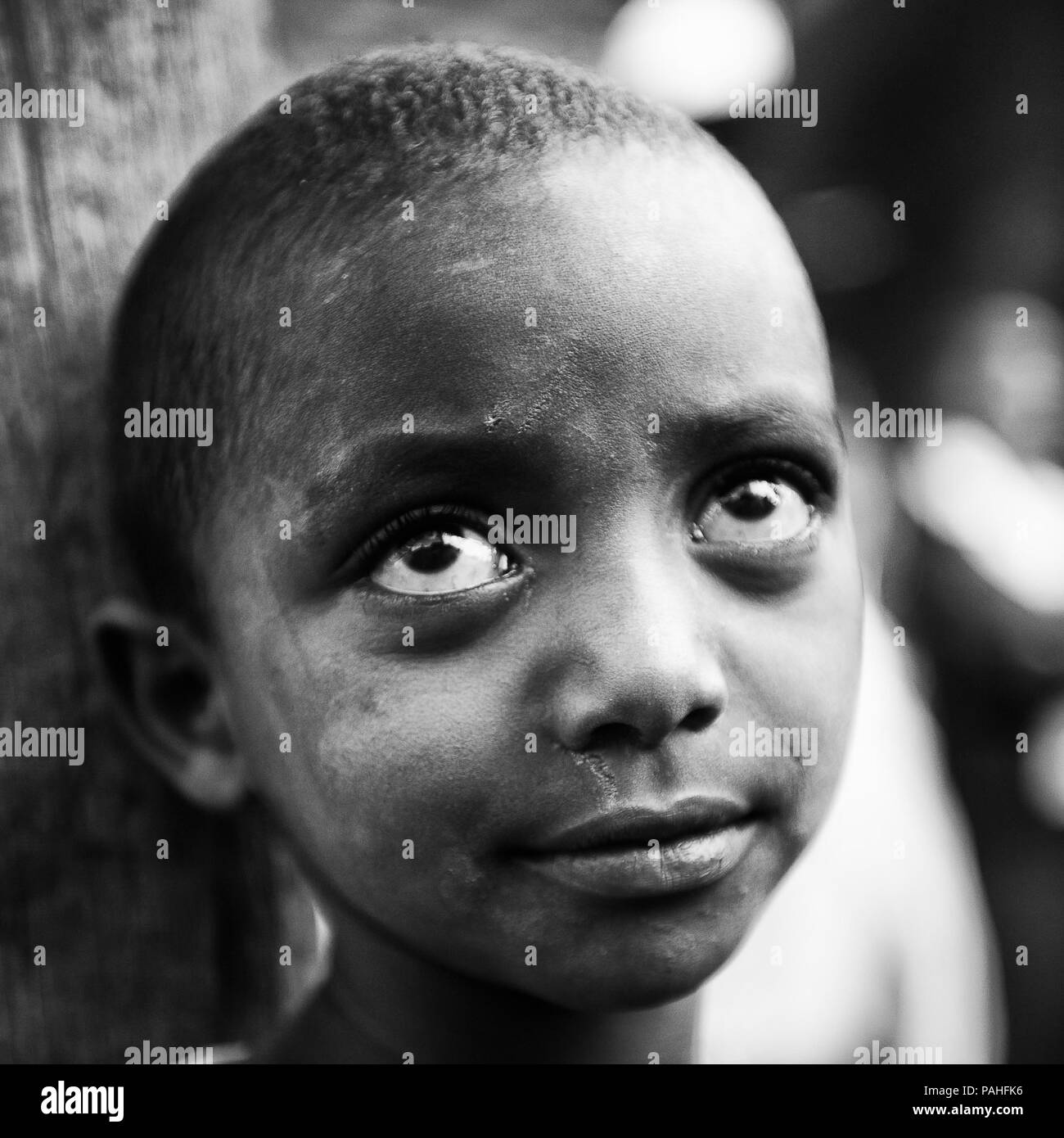 AKSUM, ETHIOPIA - SEP 27, 2011: Portrait of an unidentified Ethiopian cute girl in old clothes in Ethiopia, Sep.27, 2011. Children in Ethiopia suffer  Stock Photo