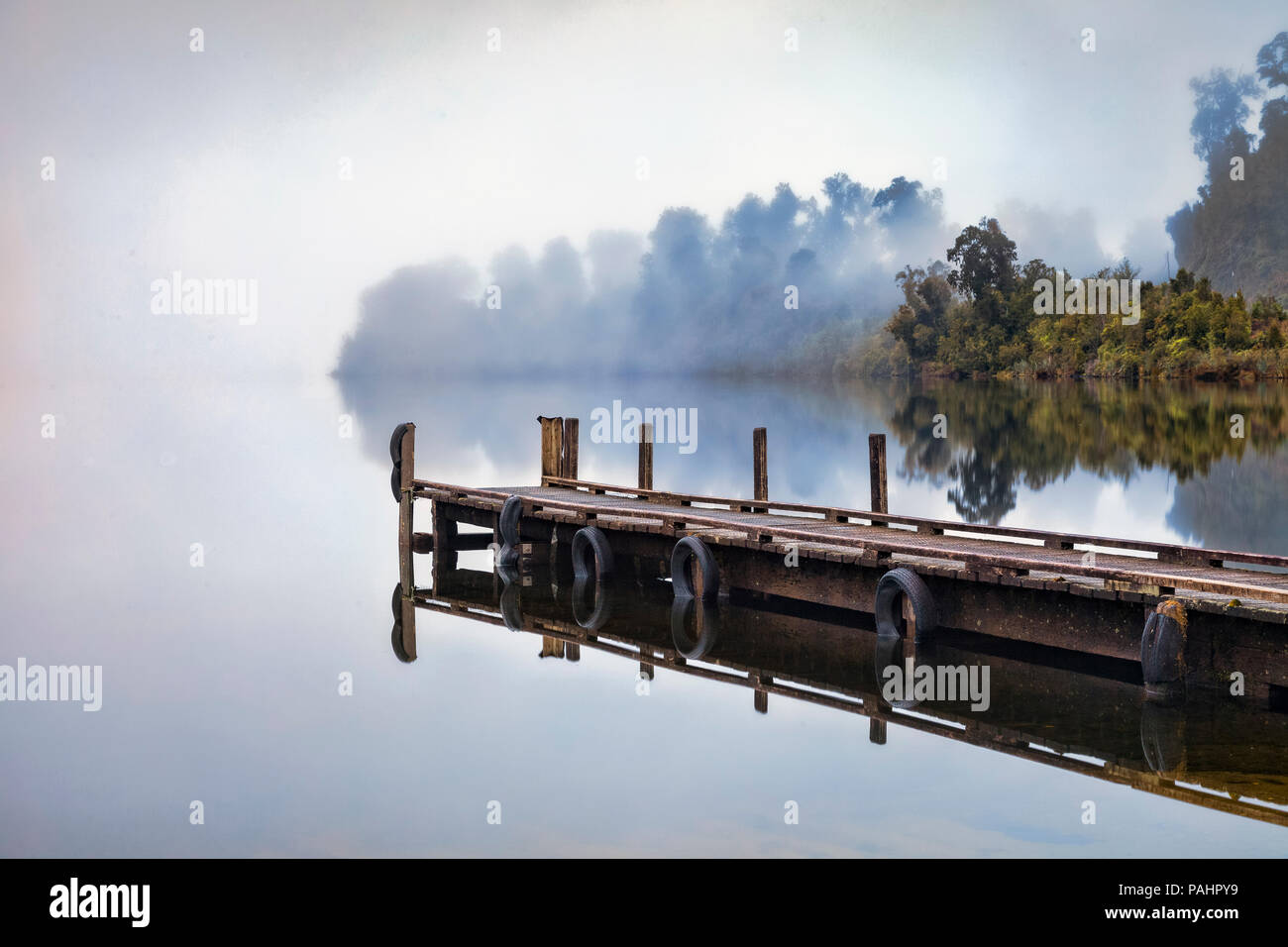 Jetty at Lake Mapourika, West Coast, New Zealand, on a foggy morning. Stock Photo
