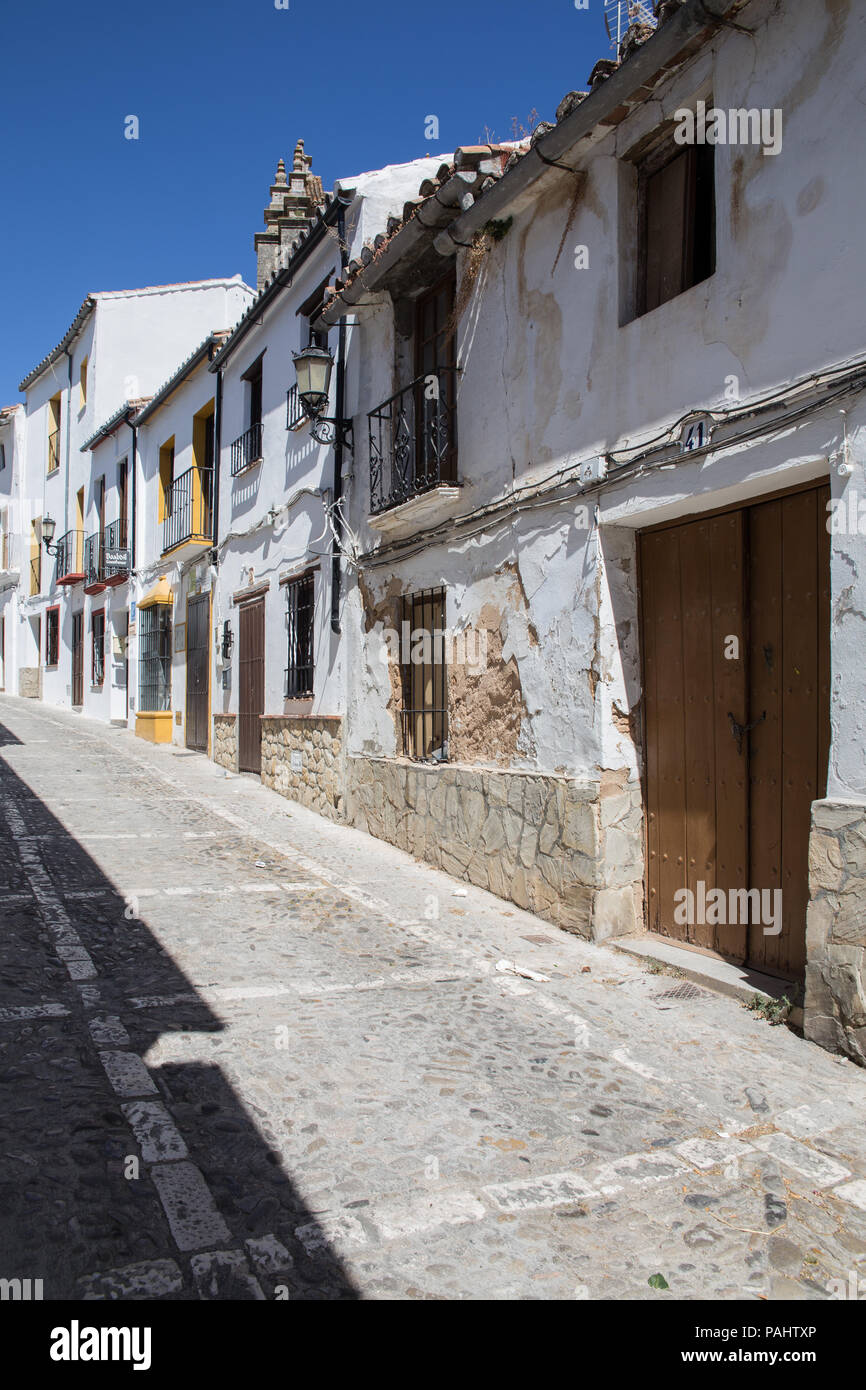 Narrow street with white facades of houses in historic district of