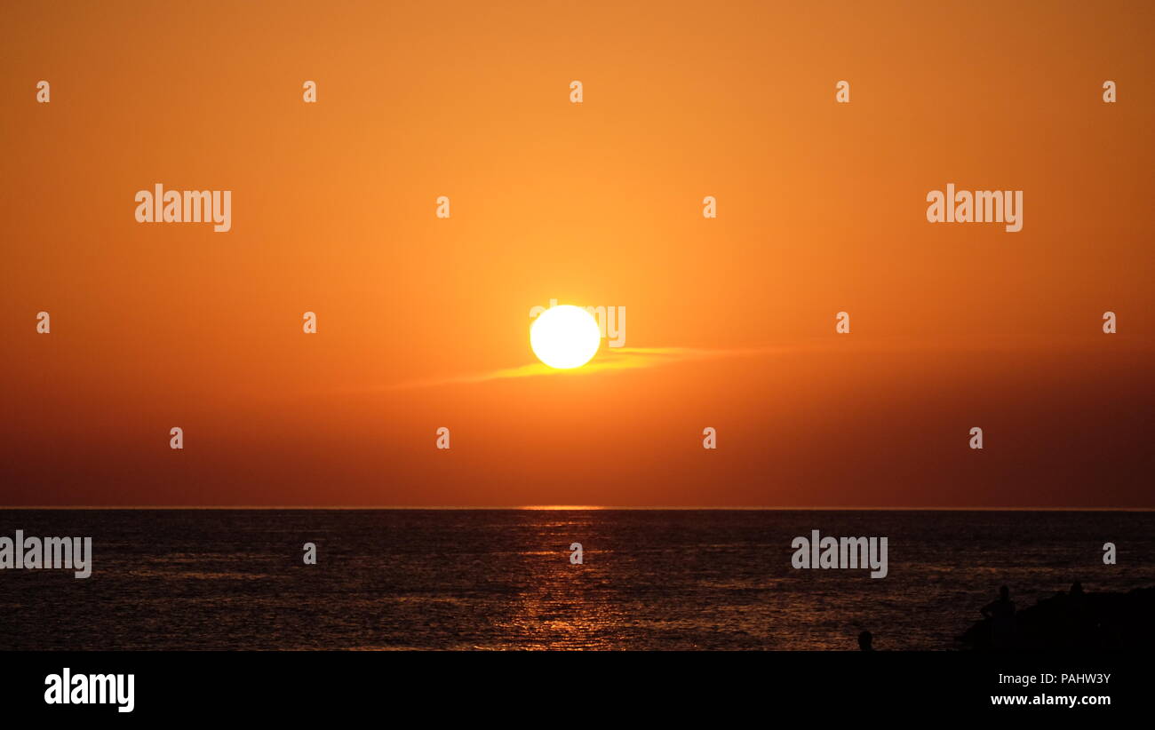 sunset by the sea boats Stock Photo - Alamy
