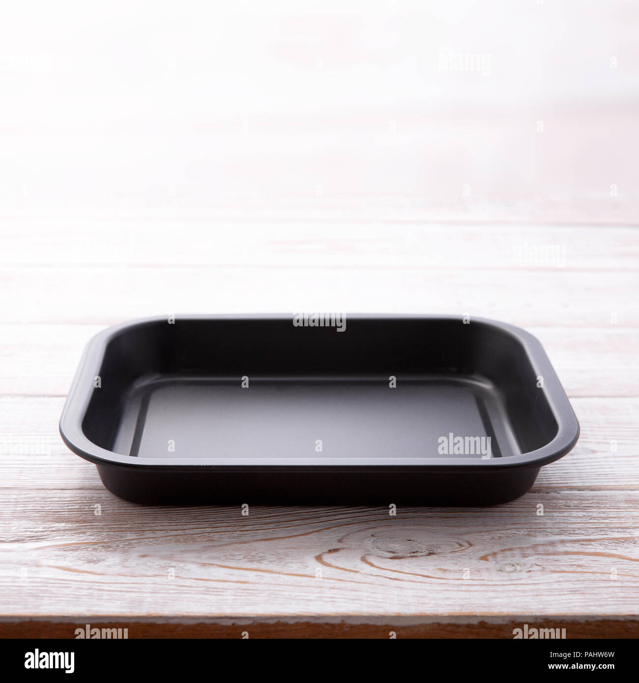 Empty baking tray for pizza close up on white wooden background top view square. Mock up for design Stock Photo