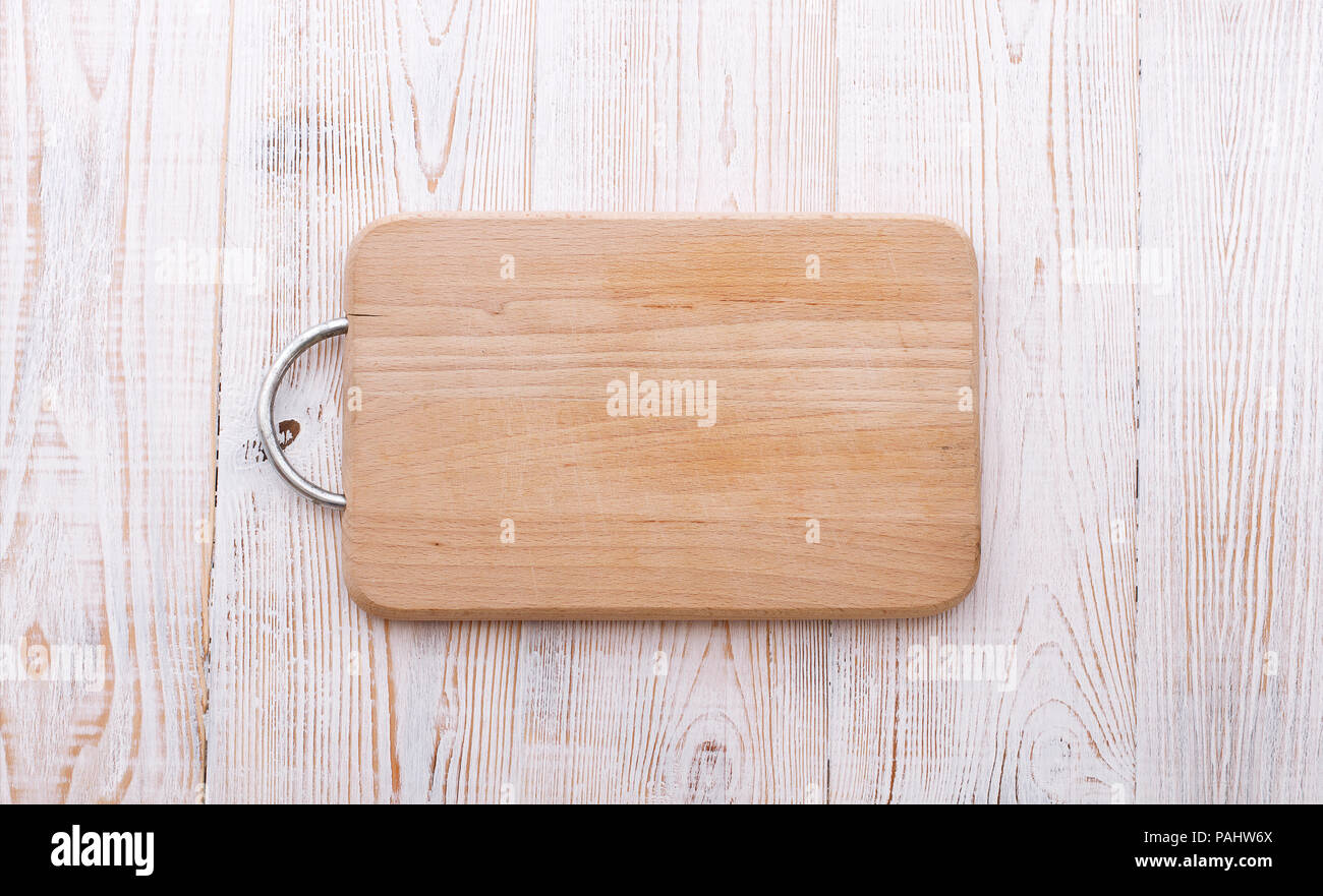 Cutting board on wooden background Stock Photo