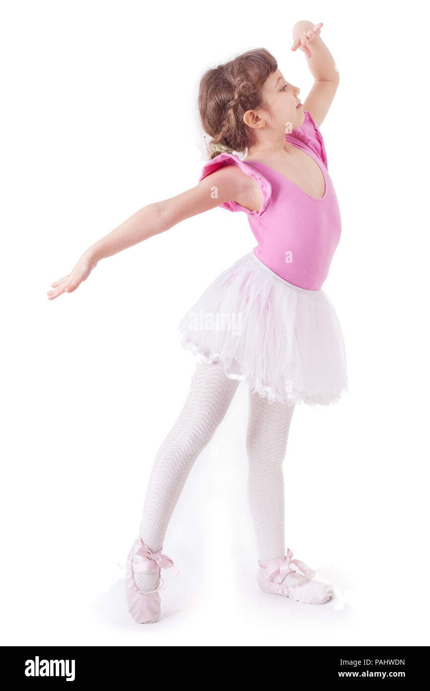 Cute, little and beautiful young ballerina girl dancing on white background. Studio shoot Stock Photo
