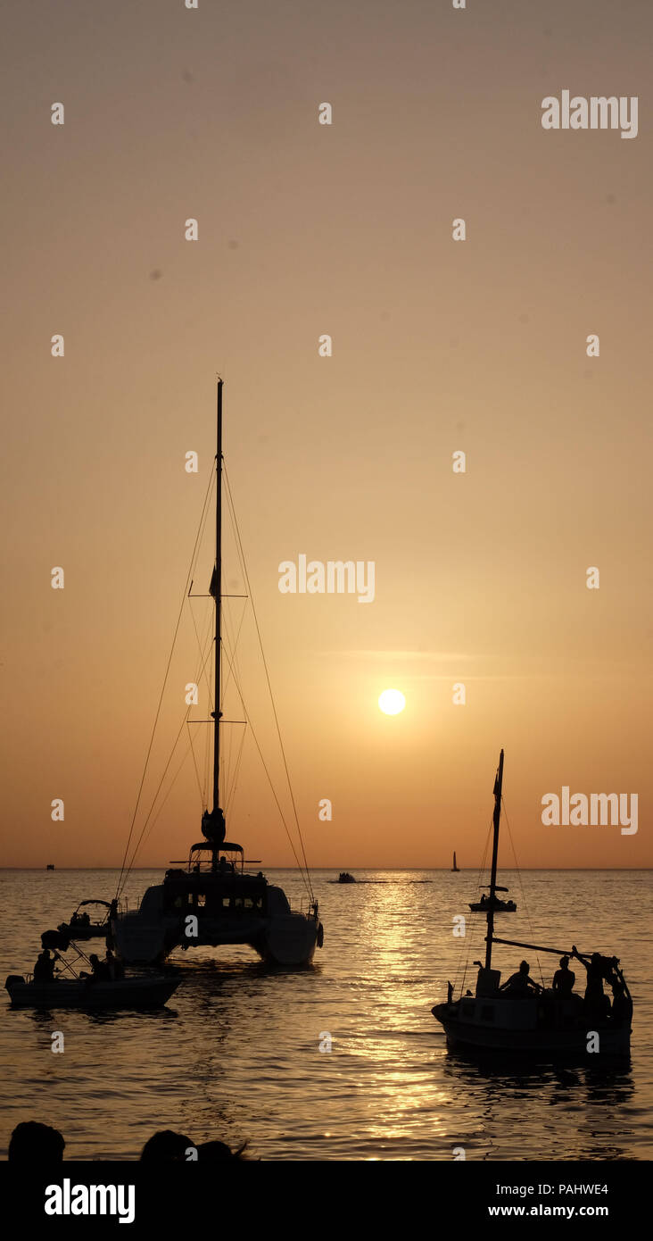 sunset by the sea boats Stock Photo - Alamy