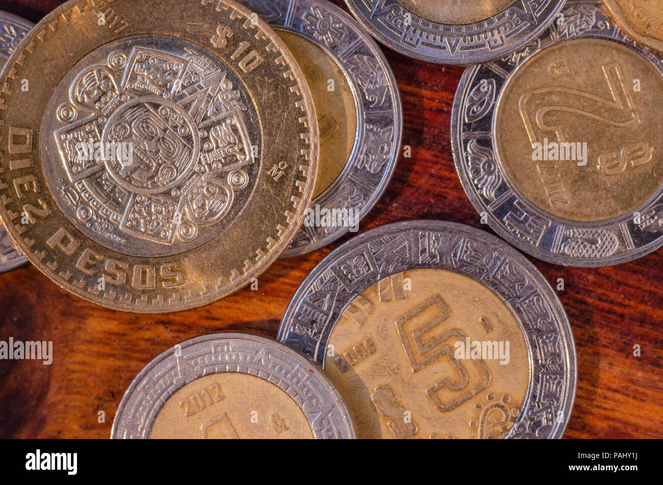 Mexican Coins of 5 and 10 pesos in the middle of other coins in