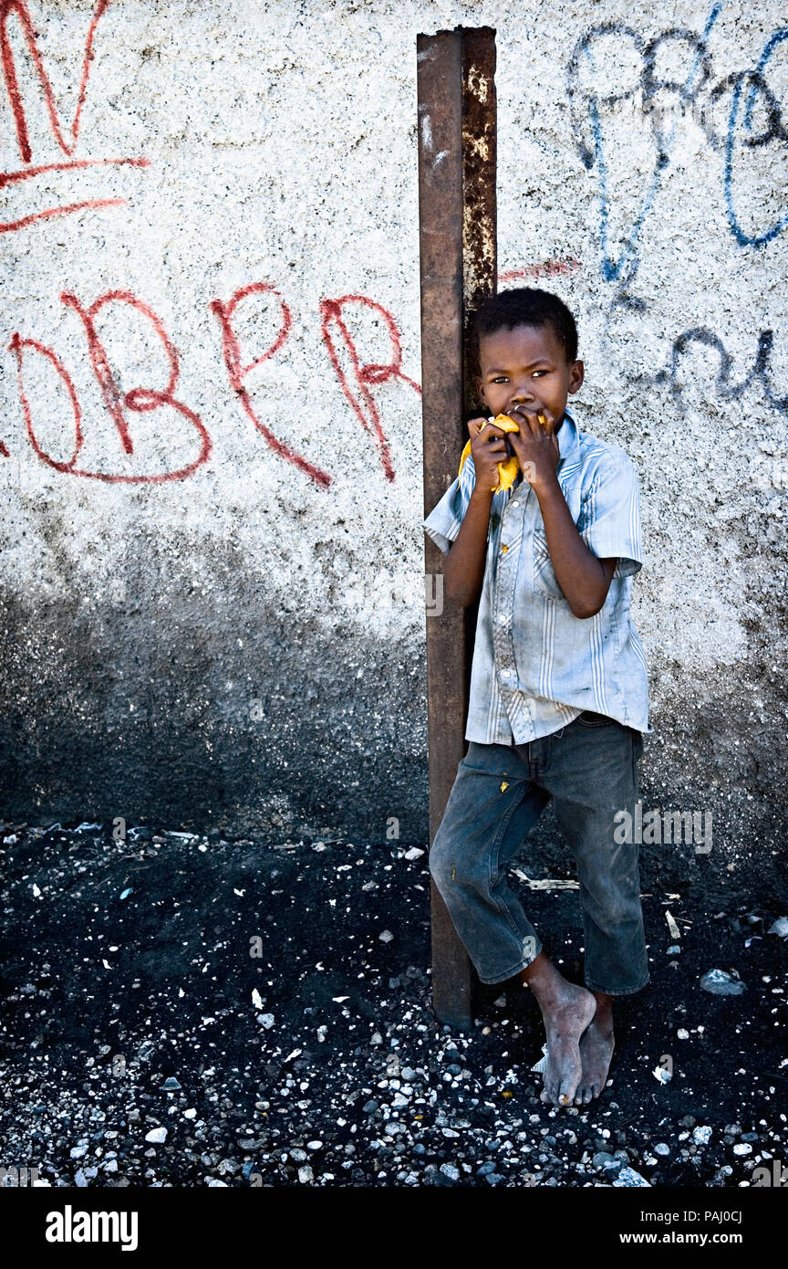 A street boy eats a mango. Cite Soleil Stock Photo - Alamy