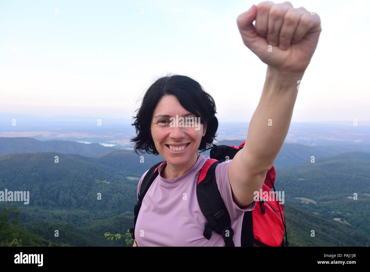 happy hiker woman to get to the top Stock Photo
