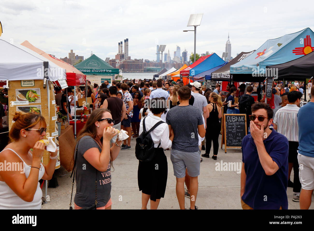 People eating snacks, and wandering around Smorgasburg Williamsburg a food festival held each weekend at East River State Park, Brooklyn, NY. Stock Photo