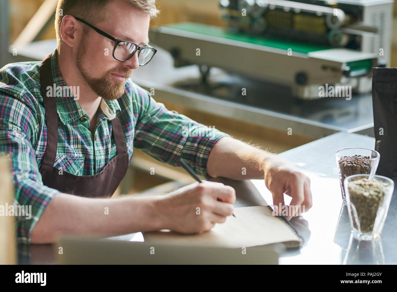 Barista Writing Making Notes on Coffee Stock Photo