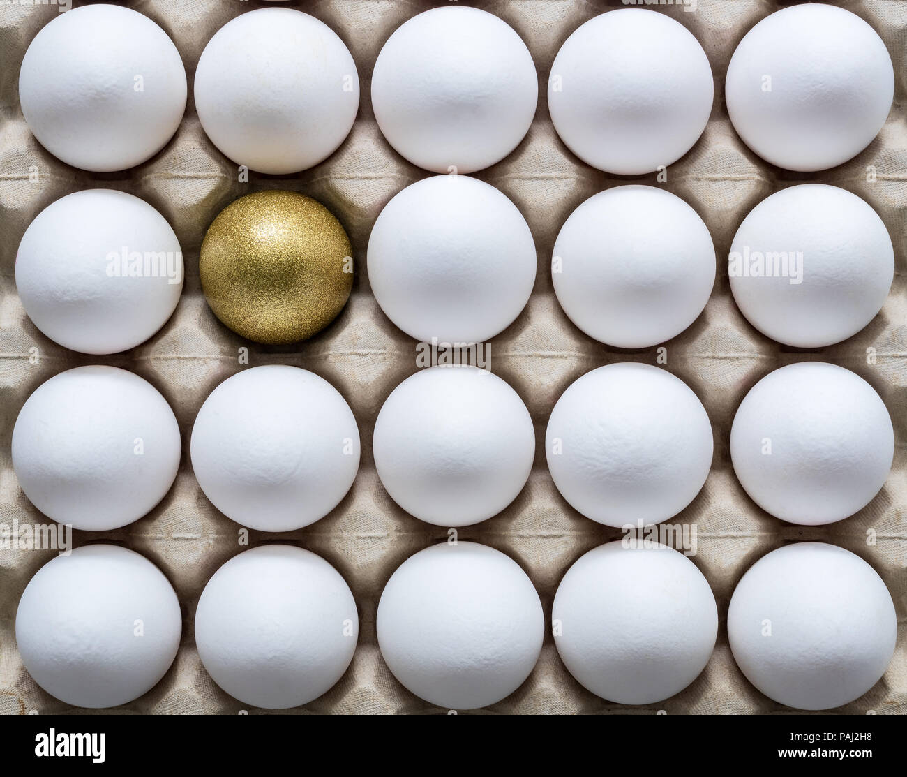 Unique golden egg in row of ordinary white eggs Vector Image