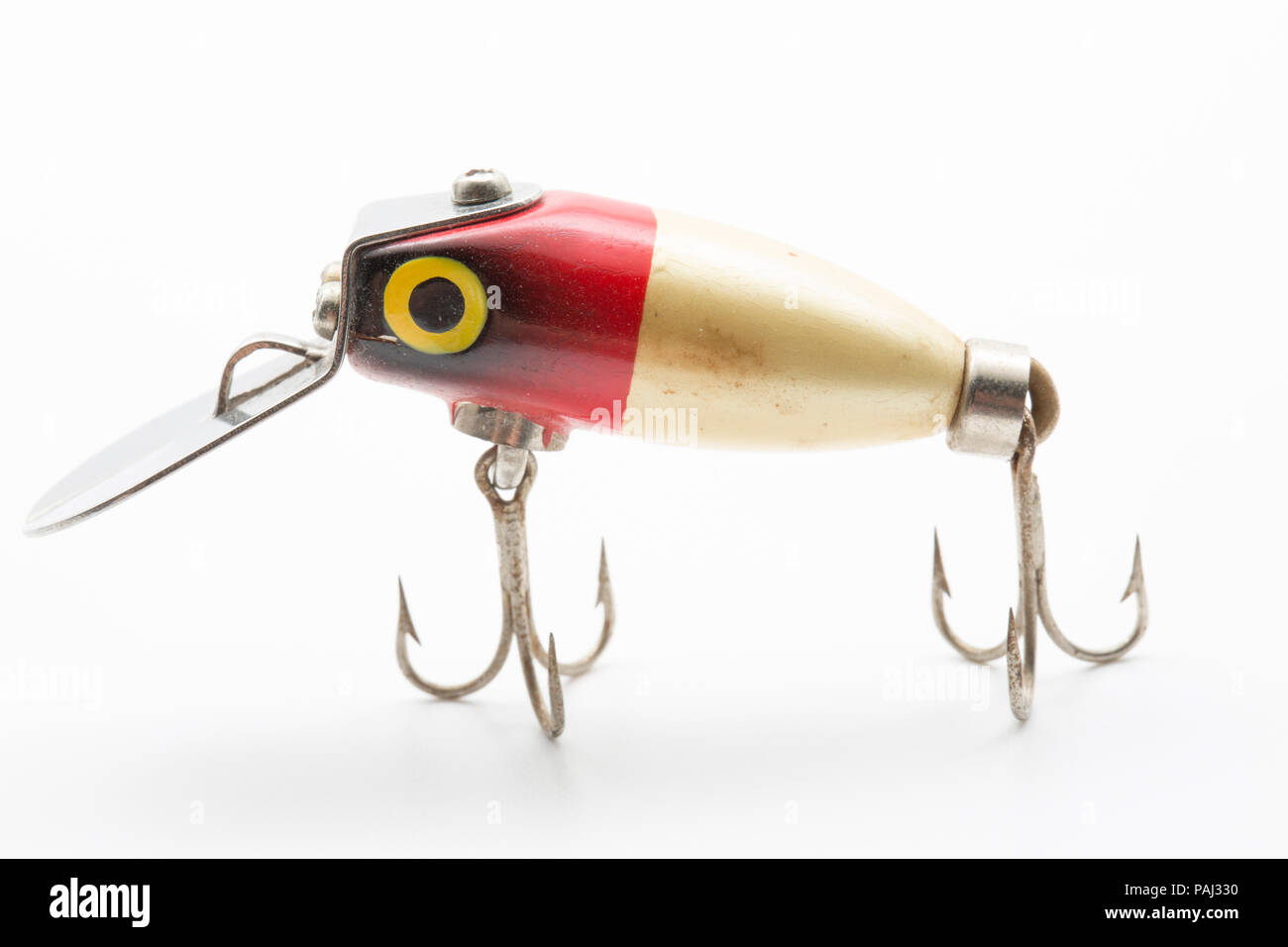 A single vintage fishing lure equipped with treble hooks, possibly by Woods  MFG, on a white background. These types of lures for catching predatory fi  Stock Photo - Alamy
