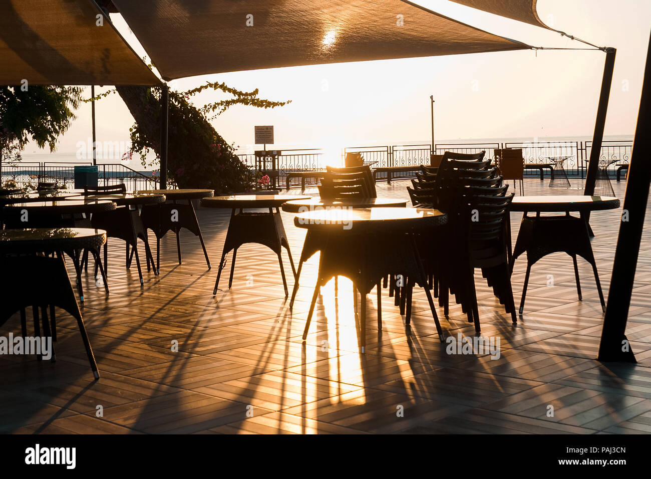 Restaurant by the sea under sunset. Cafe on the seashore. Sea under sunset. Stock Photo