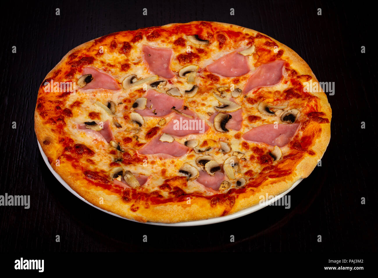Delicious pizza with ham and cheese Stock Photo Alamy