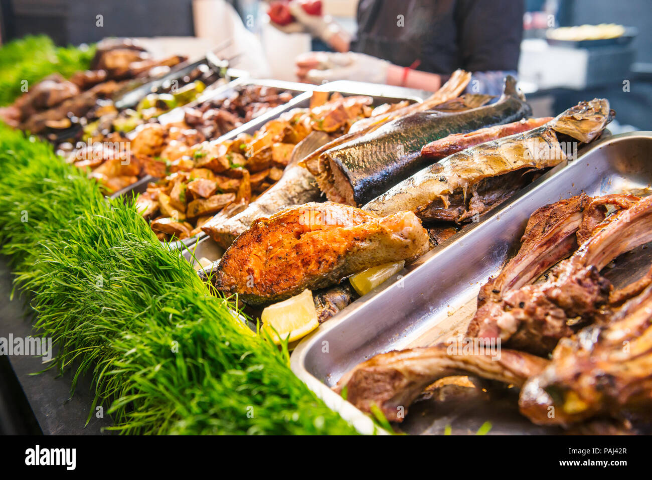 Outdoor Cuisine Culinary Buffet with healthy take away meal - grilled vegetables, fish and meat on the street food culinary market, festival, event. S Stock Photo