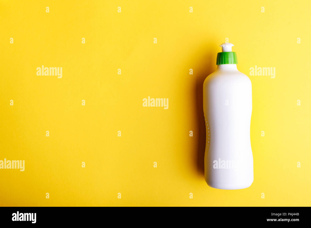 Detergent on a yellow background, space for text Stock Photo