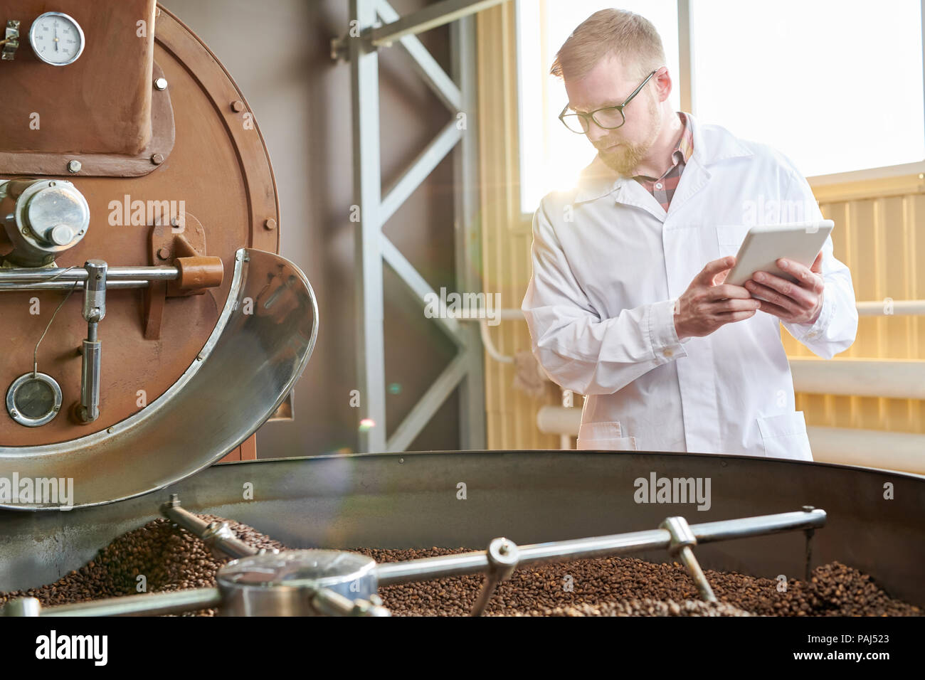 Worker Roasting Coffee at Factory Stock Photo Alamy