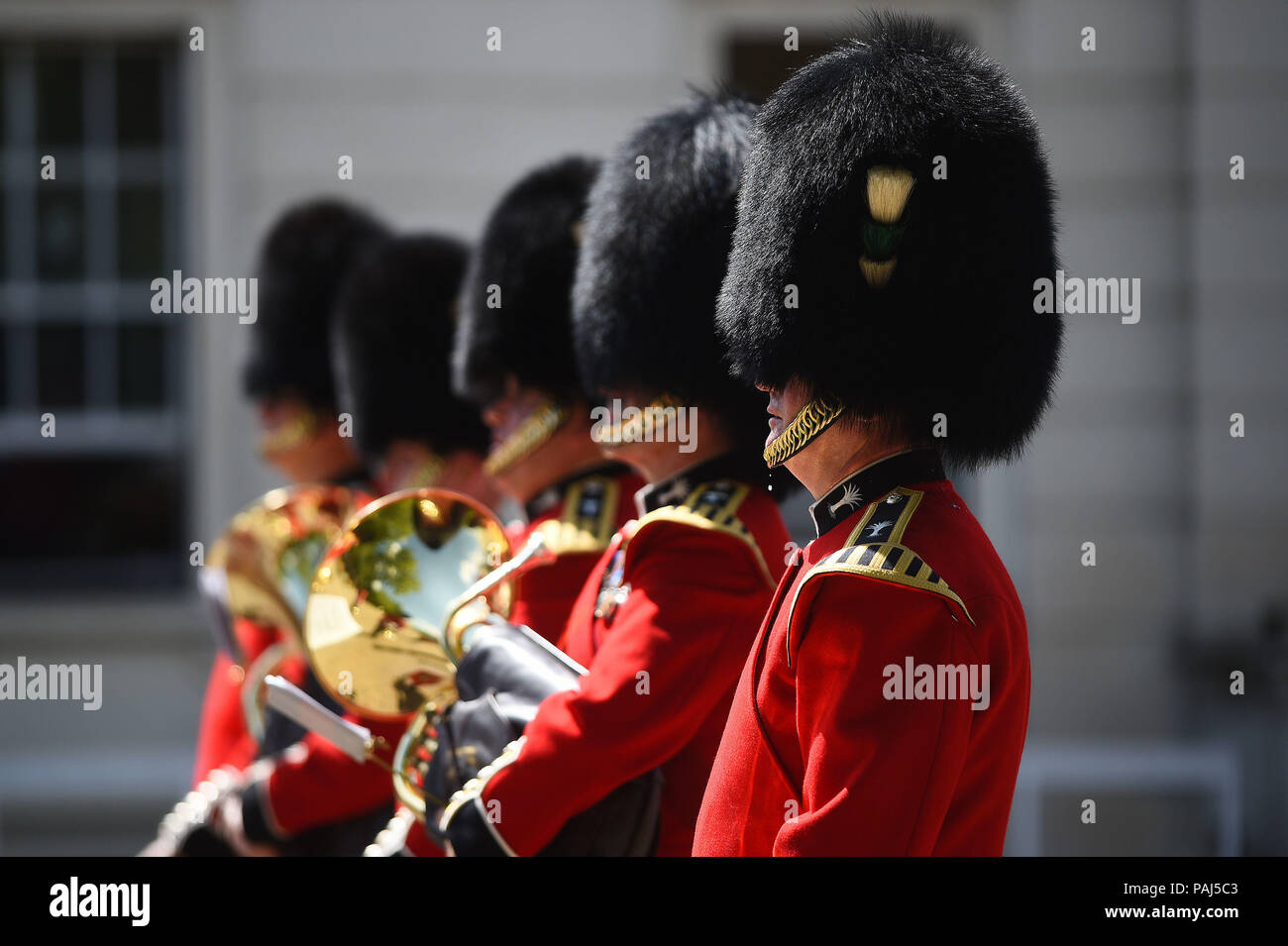 A bead of sweat falls from a member of The Queen's Guard as he takes part in the Changing the Guard ceremony at Wellington Barracks in London, as the hot weather continues across the country. Stock Photo