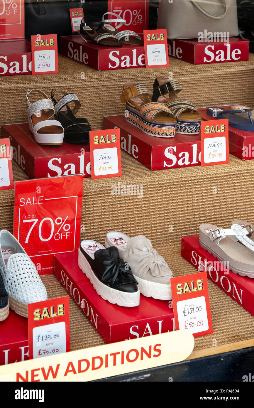 Display of shoes and sandals in Shoon shop window Stock Photo