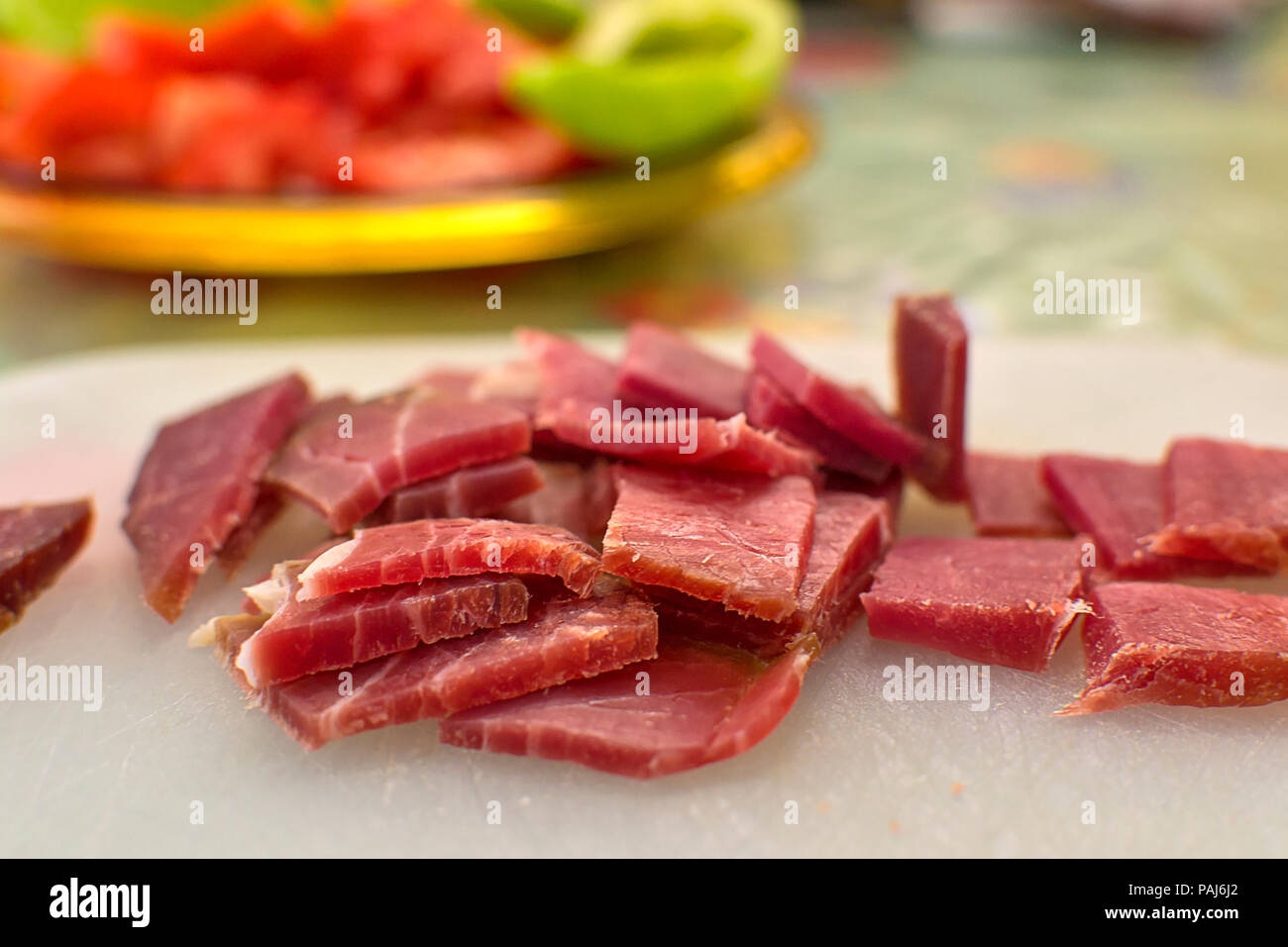 Sliced domestic ham on a kitchen table. Stock Photo