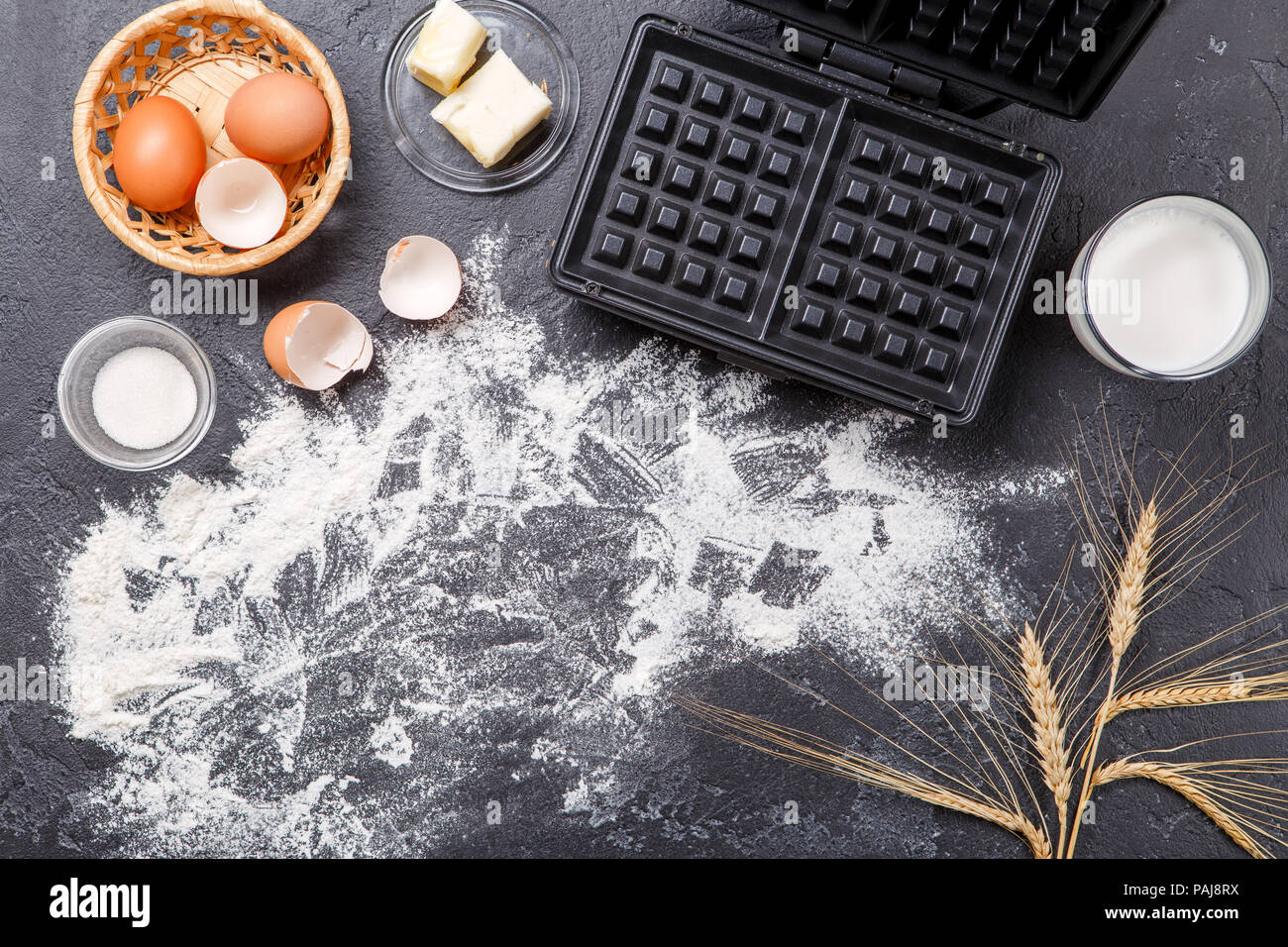 Photos on top of ingredients for Viennese waffles, waffle iron, on