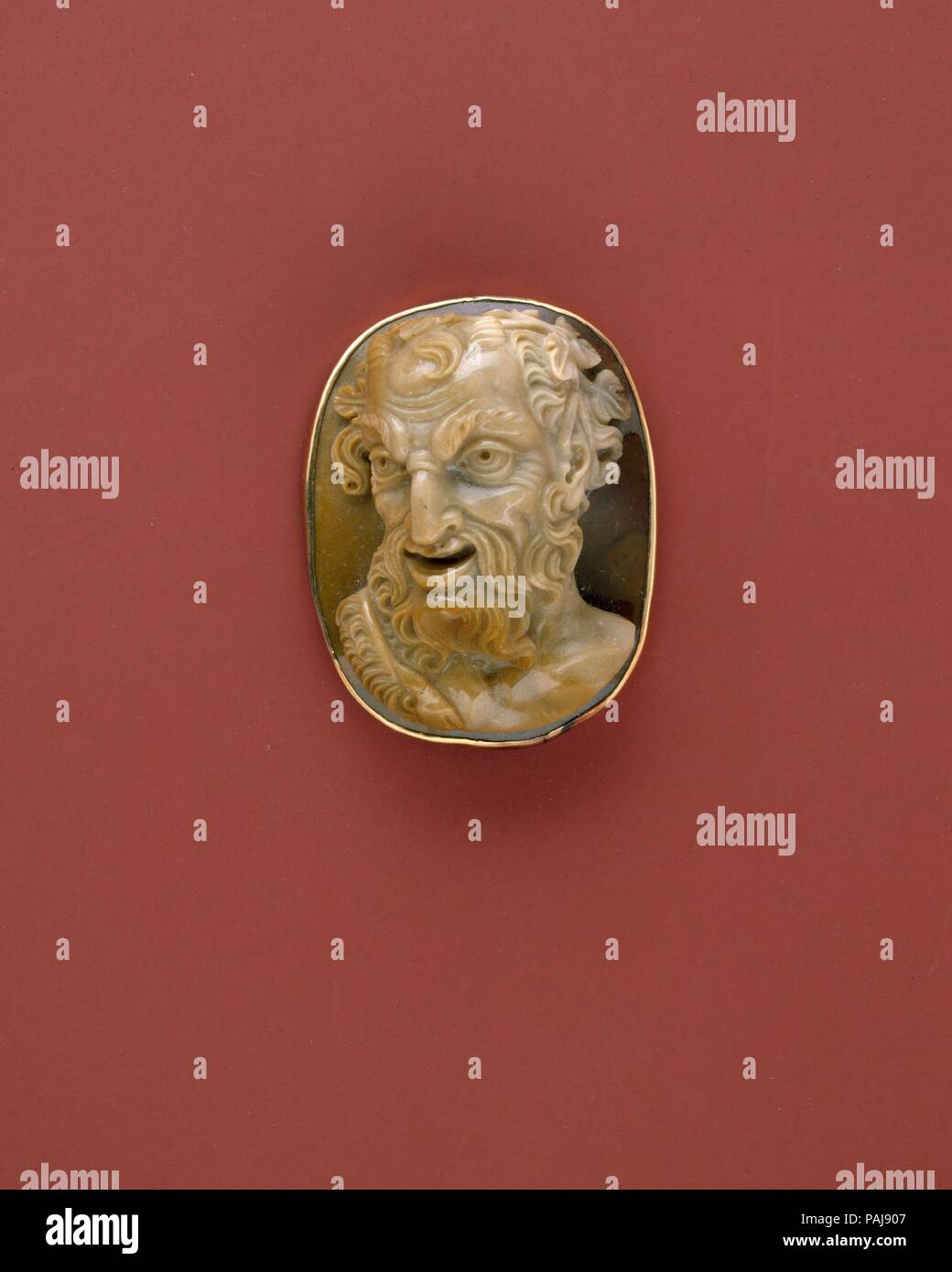 Cameo with the Head of a Satyr. Culture: probably Italian. Dimensions: 2 1/8 × 3/16 in. (5.4 × 0.5 cm). Date: late 18th or early 19th century.  The tradition of representing satyrs on intaglios and cameos is an ancient one, stretching back at least as far as sixth-century Greece. This cameo, with its forced perspective and strong, unidealized image, belongs to a rather late stage in the evolution of the representation of the sylvan deity. It was probably made in Italy, the chief center of cameo production in the late eighteenth and nineteenth century, as it is today.  [Clare Vincent, The Jack  Stock Photo