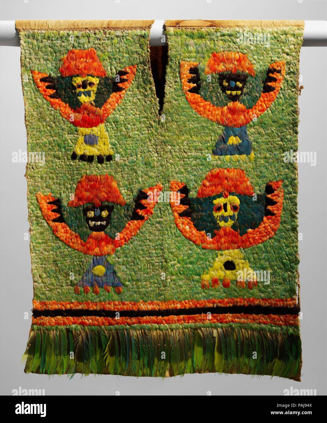 Feathered Tabard. Culture: Ica (?). Dimensions: H. 30 × W. 25 in. (76.2 × 63.5 cm). Date: 15th-early 17th century.  Feathers were considered luxury materials in ancient Peru. They were used to embellish elite costume for thousands of years. Textiles densely covered with the brilliantly colored feathers of tropical rainforest birds are among the most spectacular works produced by ancient Andean artists. Feathered garments lent the wearer status and prestige and indicated wealth. Far-reaching contacts were necessary to bring the Amazonian bird feathers over the long distances between the eastern Stock Photo