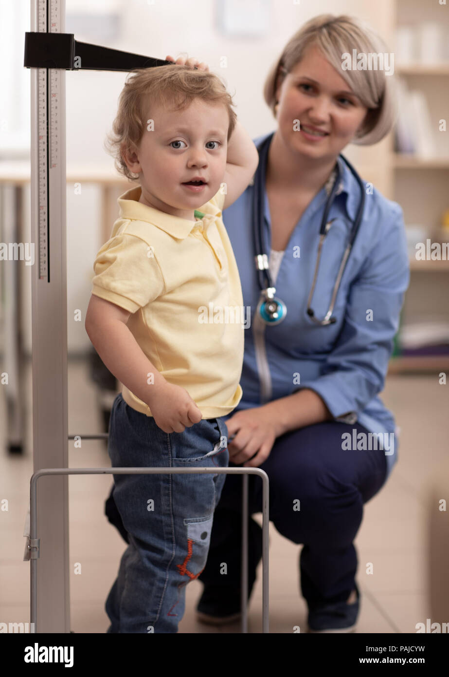 Doctor measuring kid's height Stock Photo
