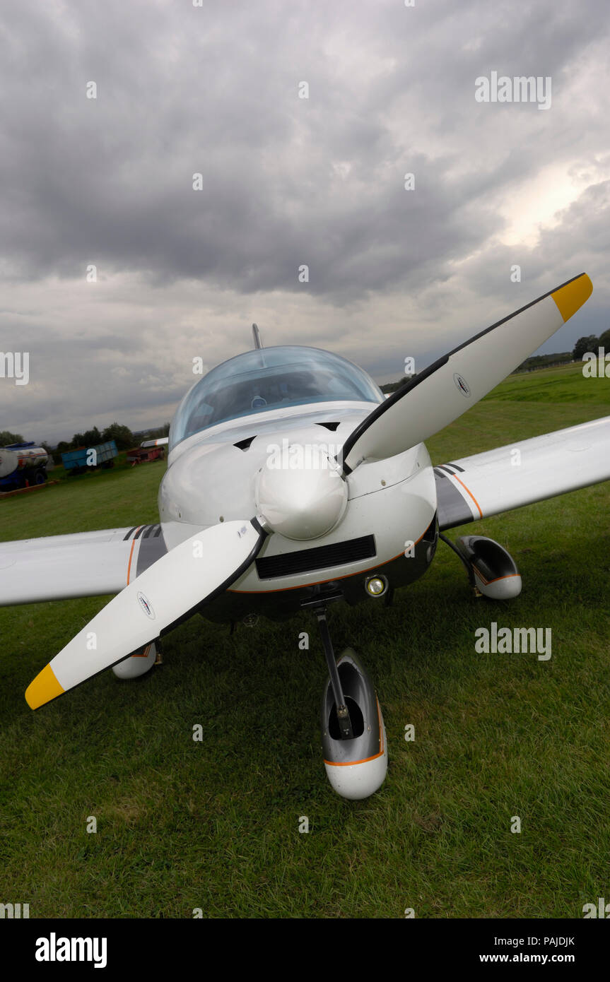 nose undercarriage, spinner, propeller and windshield of a Czech Aircraft Works SportCruiser parked on the grass Stock Photo