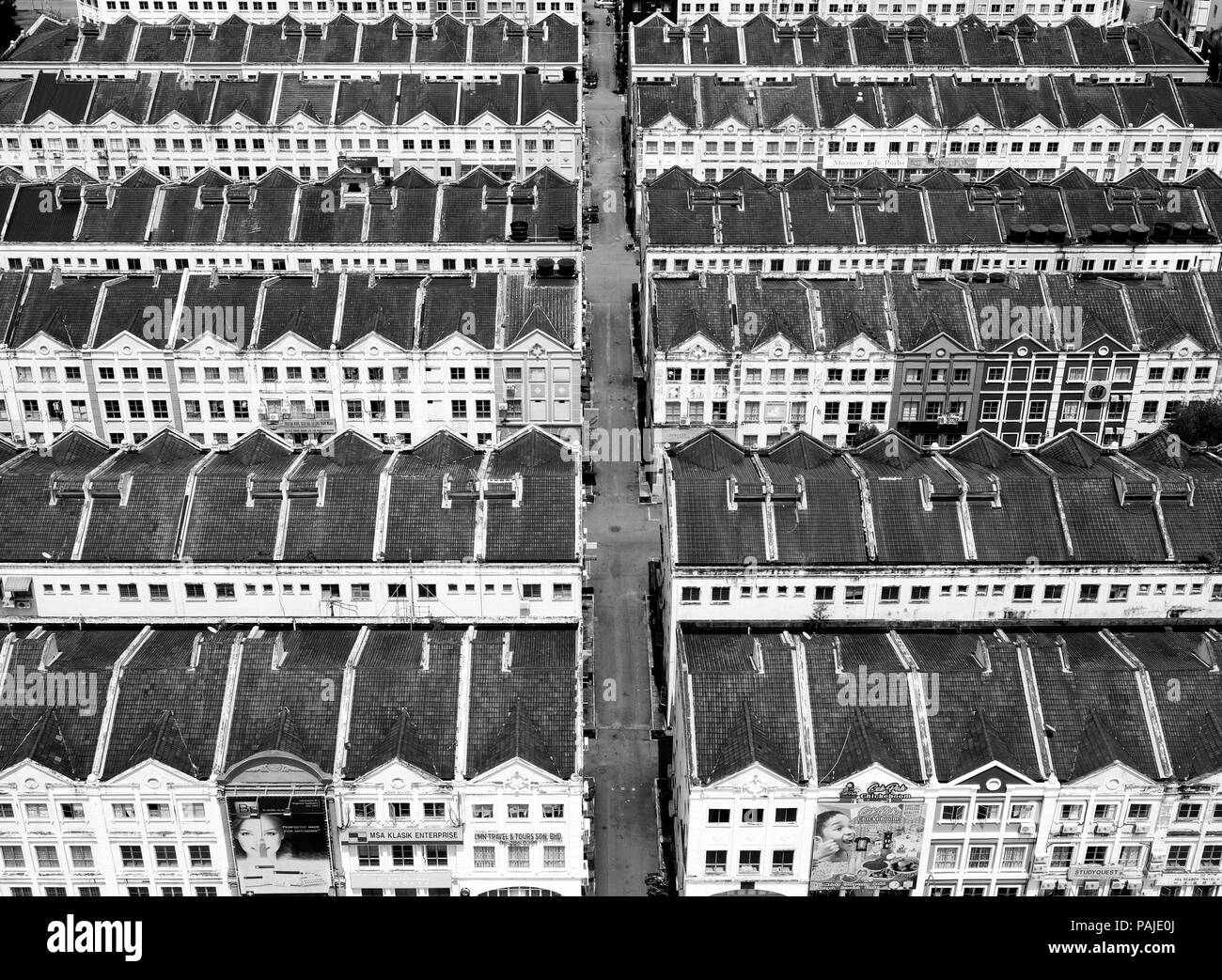 Overhead view of rows of colourful and white historical dutch colonial terraced houses in Melaka, Malaysia they are in repeating straight rows, black  Stock Photo