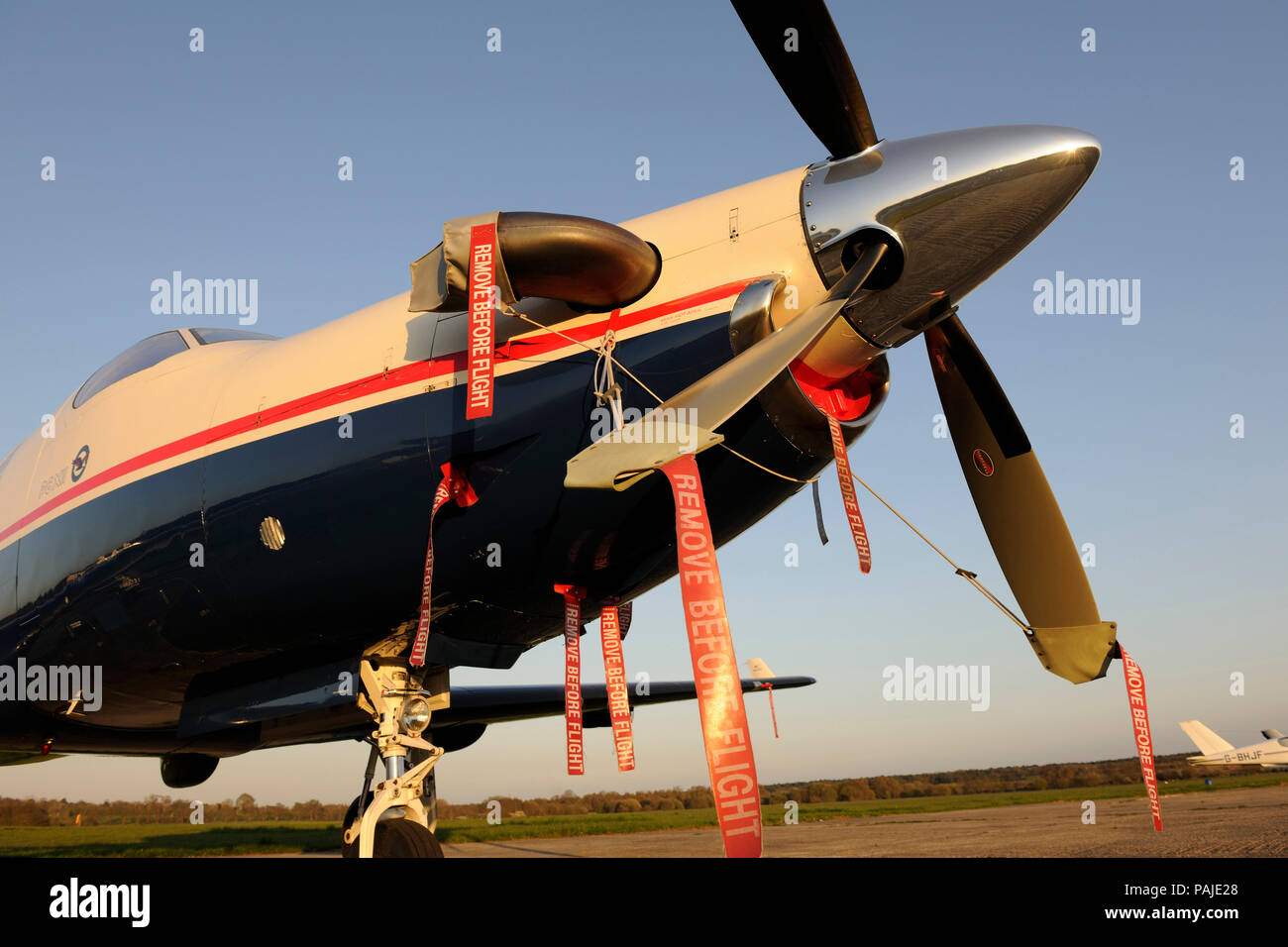 'Remove Before Flight' ribbons, propellers and Pratt & Whitney Canada PT6A-67B engine-cowling of Pilatus PC-12-45 parked Stock Photo